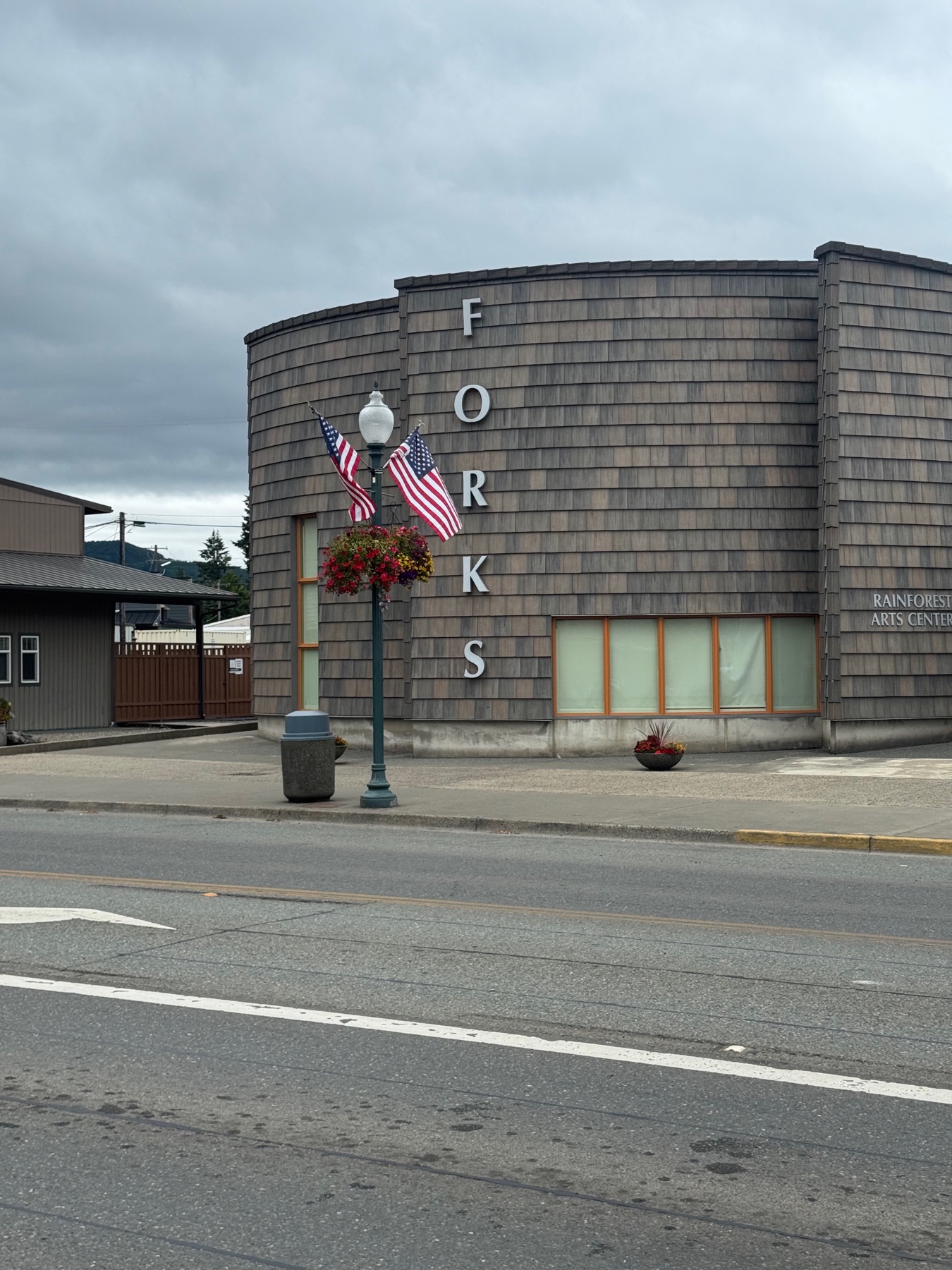A distinctive shingled building in downtown Forks with the word FORKS lettered vertically down its corner